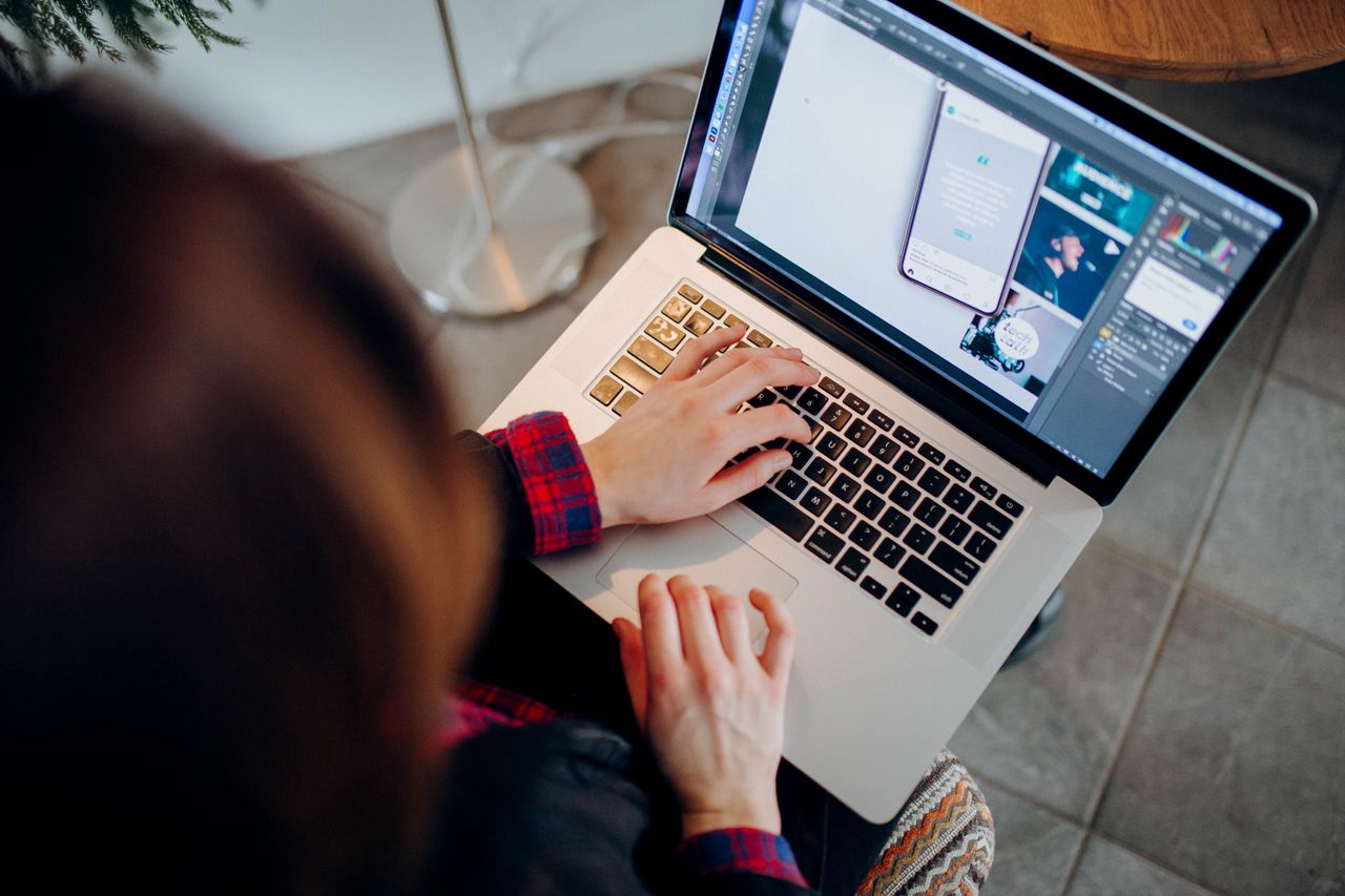 Mastering the First Impression: Your intriguing post title goes here Close-up of a person working on a laptop with graphic design software.